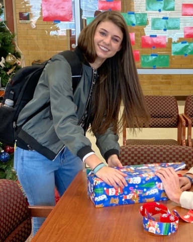 Student wraps a present.