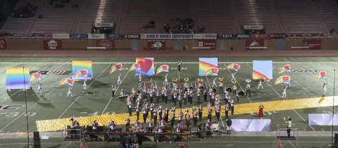 MMHS marching band and color guard performing on football field