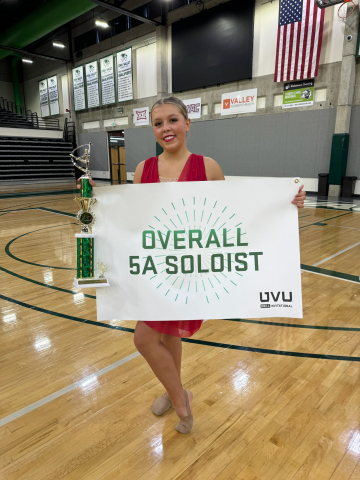 student holding overall 5a soloist sign