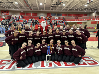 Group photo of MMHS drill team with trophy